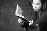 Woman reading book in wooden chair.jpg