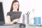 Woman reading newspaper at her desk 3.jpg