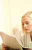 Woman reading newspaper with mug of coffee.jpg