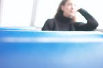 Woman sitting in blue vinyl seat uid 1283666.jpg