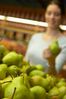 Woman squeezing pears in grocery store an 4.jpg