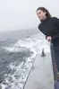 Woman standing on edge of boat uid 1283633.jpg