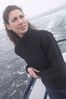 Woman standing on edge of boat uid 1283635.jpg