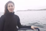 Woman standing on edge of boat uid 1283636.jpg