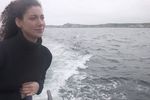 Woman standing on edge of boat uid 1283637.jpg