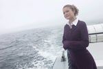 Woman standing on edge of sailboat uid 1283628.jpg