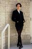 Woman standing with hands in pockets.jpg