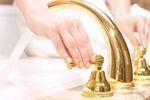 Woman turning off bathtub taps.jpg