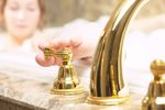 Woman turning off faucet with her toes 1.jpg