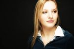 Young blonde woman with a black background uid 1452724.jpg