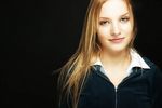 Young blonde woman with a black background uid 1453099.jpg