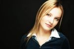Young blonde woman with a black background uid 1453129.jpg