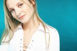Young blonde woman with a blue background uid 1453111.jpg