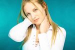 Young blonde woman with a blue background uid 1462750.jpg