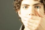 Young man covering his mouth.jpg